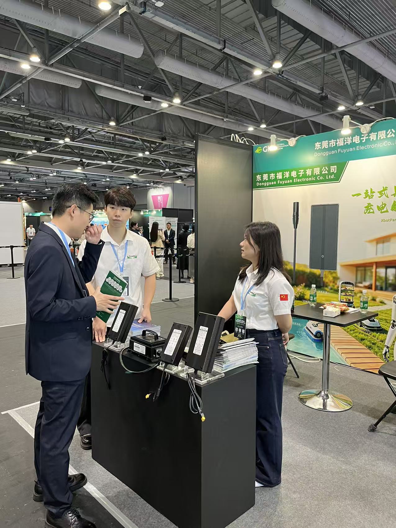 Fuyuan Electronic engineer explaining charger specifications to a show visitor